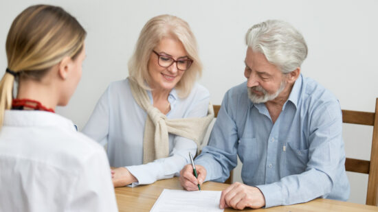 Aged,Couple,Signing,Contract,Making,Investment,At,Meeting,With,Financial